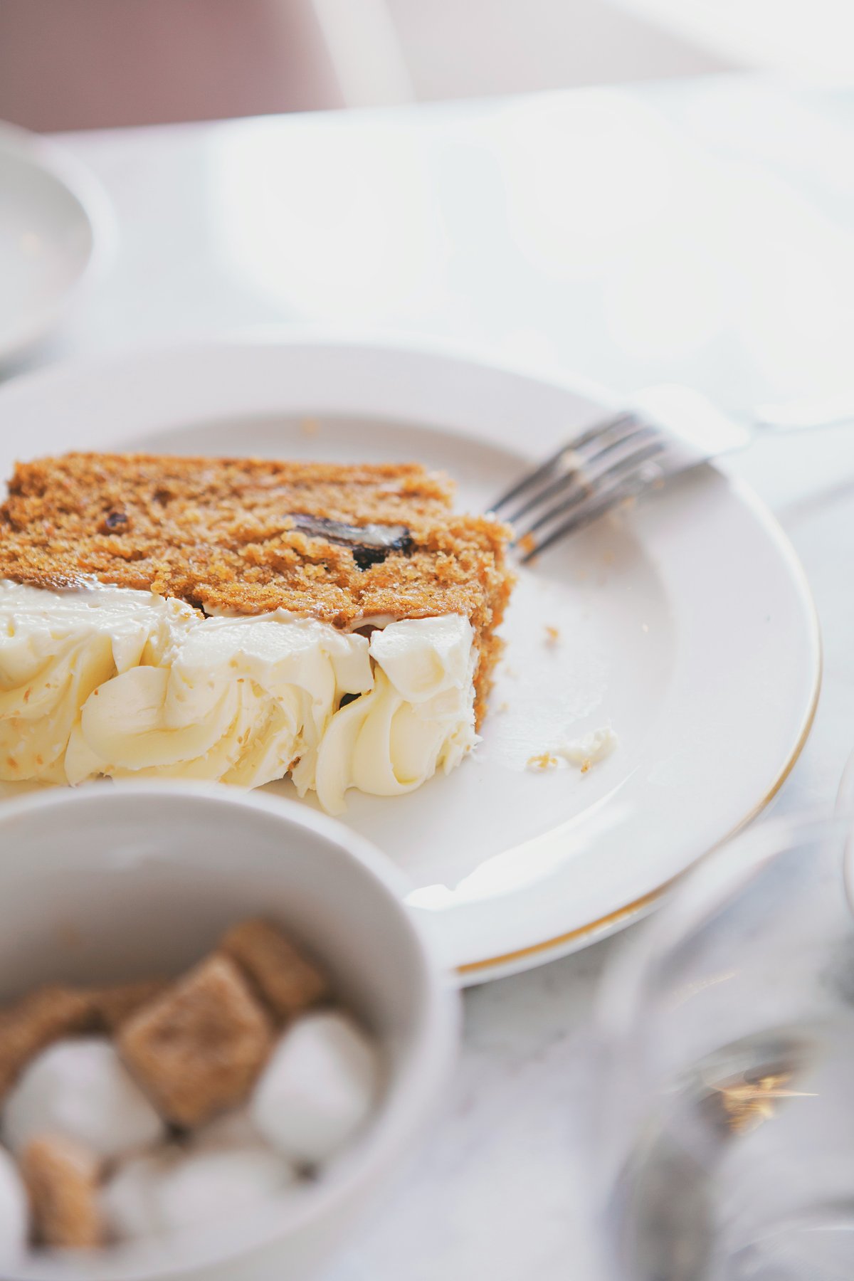 A slice of spiced cake with cream cheese frosting