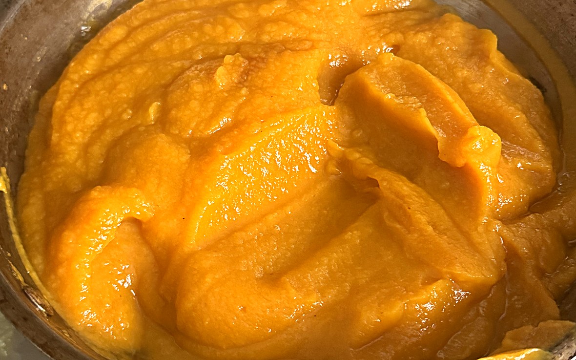 A pot of smooth homemade pumpkin puree, roasted and blended