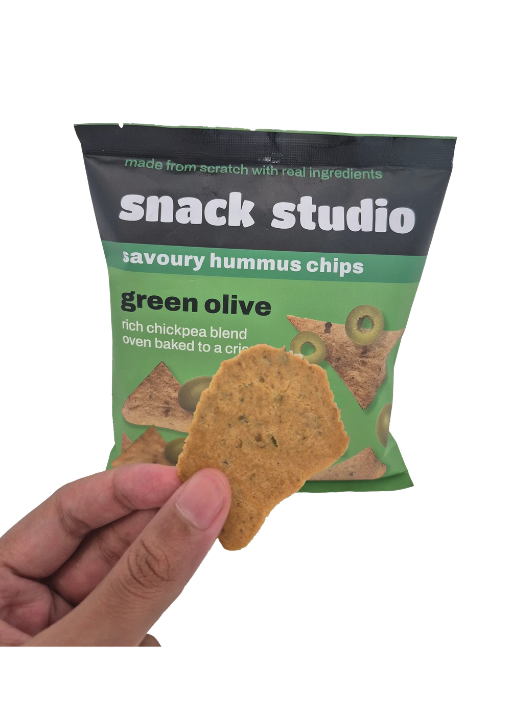 Holding up a Snack Studio green olive hummus chip in front of the packet