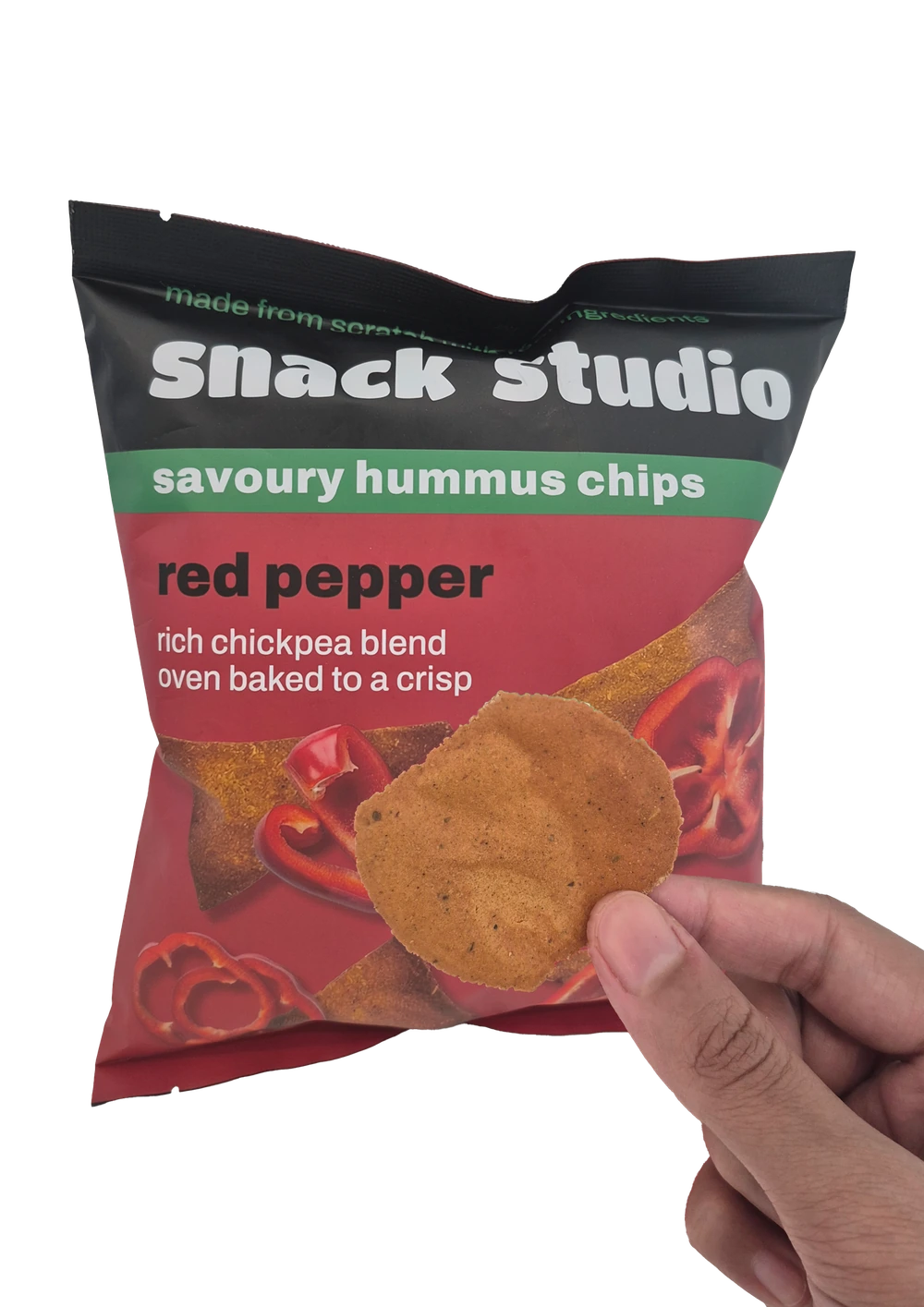 Holding up a Snack Studio red pepper hummus chip in front of the packet